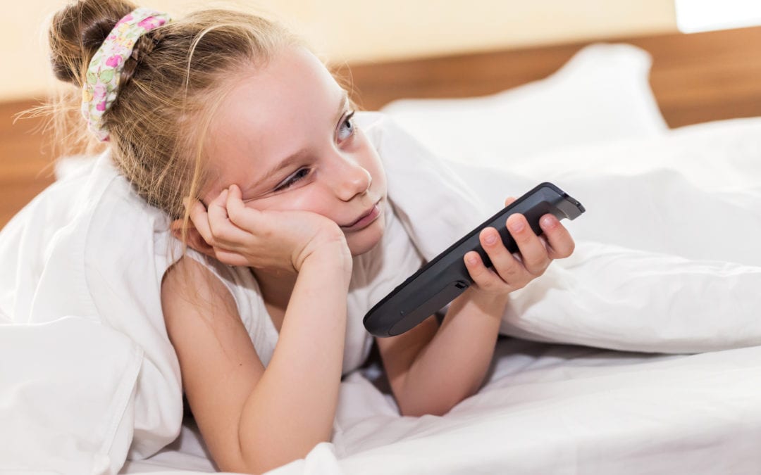 Young bored girl watching TV.