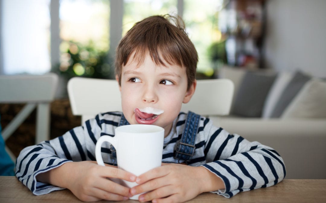 Young boy with milk on his lip
