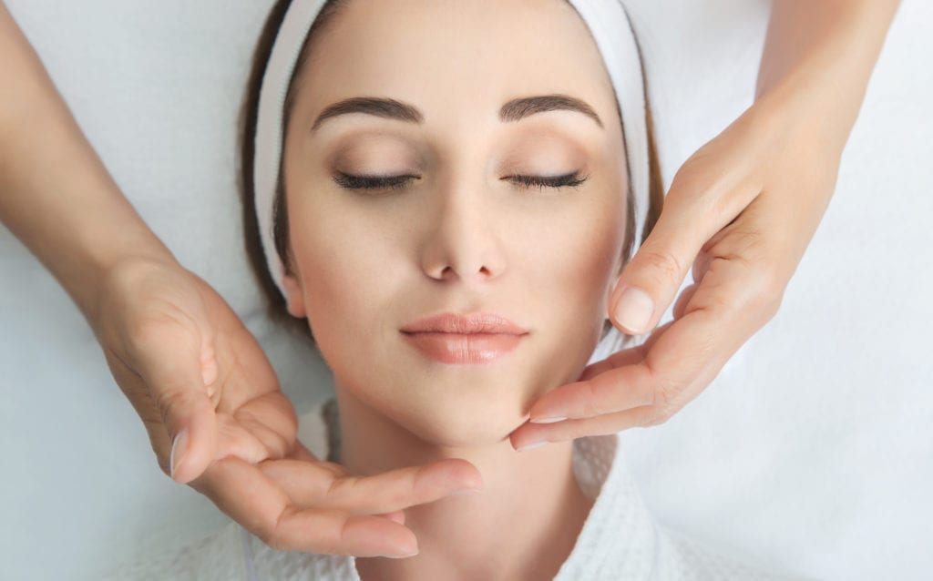 Relaxed Woman Receiving A Facial Massage At A Medi Spa Slma