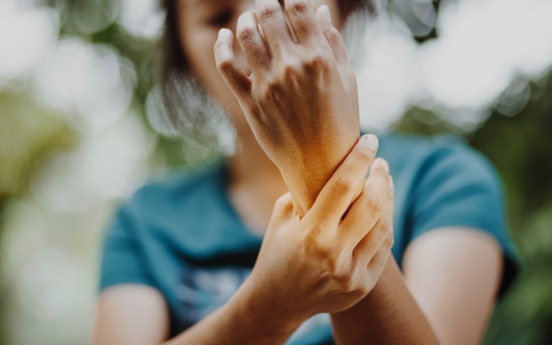 Woman with arthritis holding hand in pain