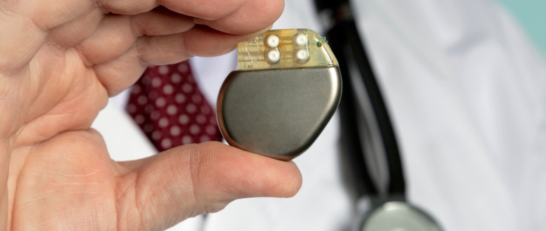 close up photo of doctor holding a pacemaker